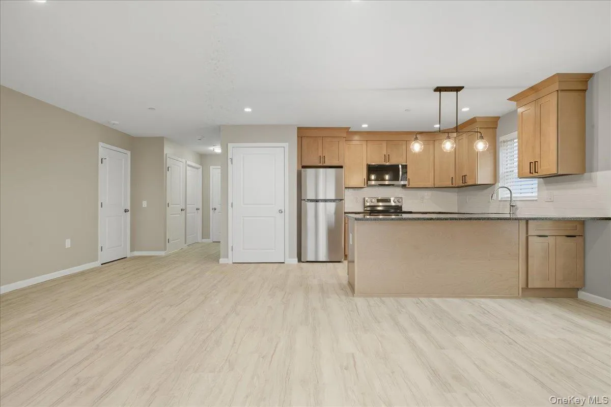 Kitchen Featuring Appliances with Stainless Steel Finishes, Hanging Light Fixtures, Peninsula & Granite Countertops, Kitchen Featuring Appliances with Stainless Steel Finishes, Hanging Light Fixtures, Peninsula & Granite Countertops,