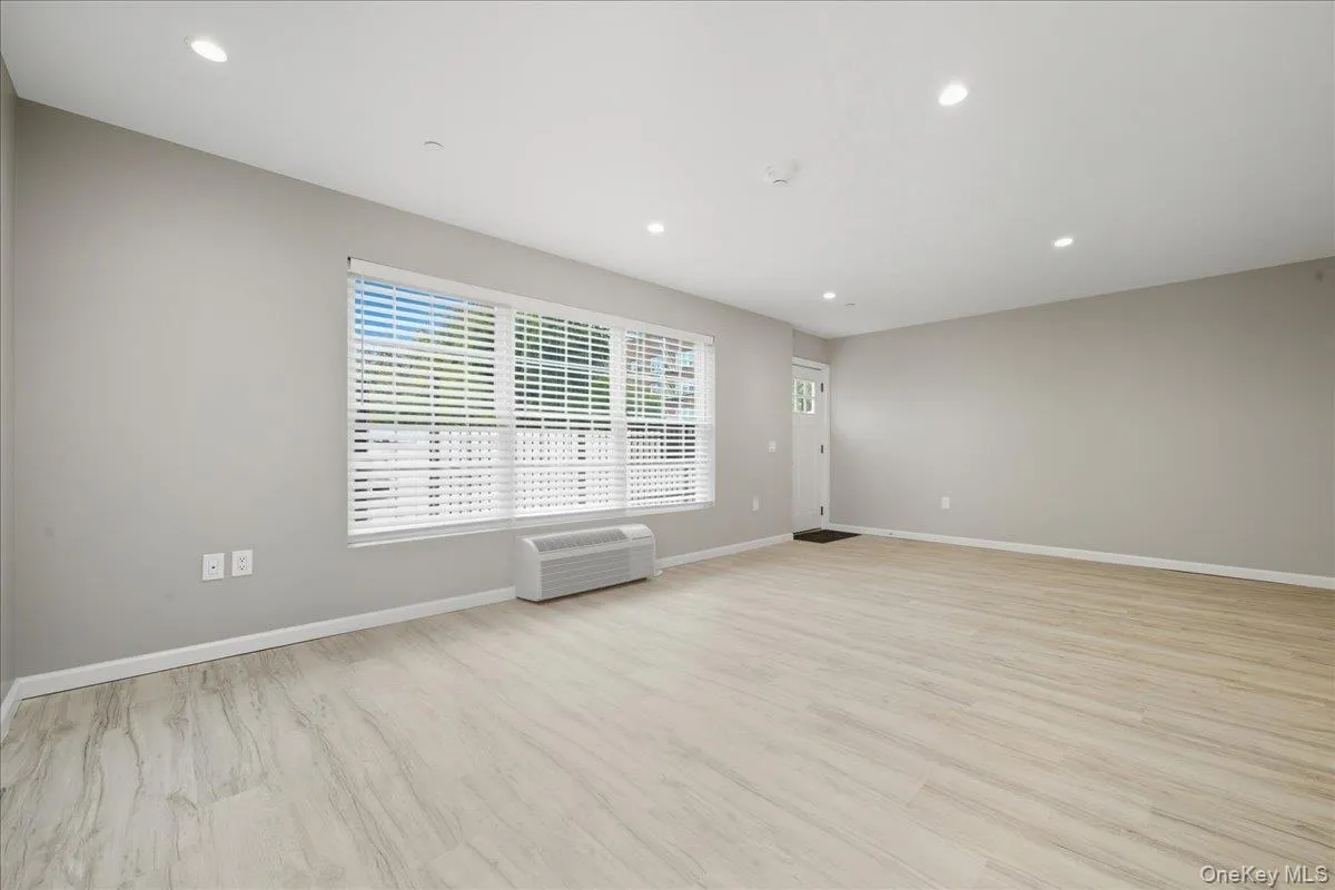 Unfurnished room with light wood-type flooring and recessed lighting Unfurnished room with light wood-type flooring and recessed lighting