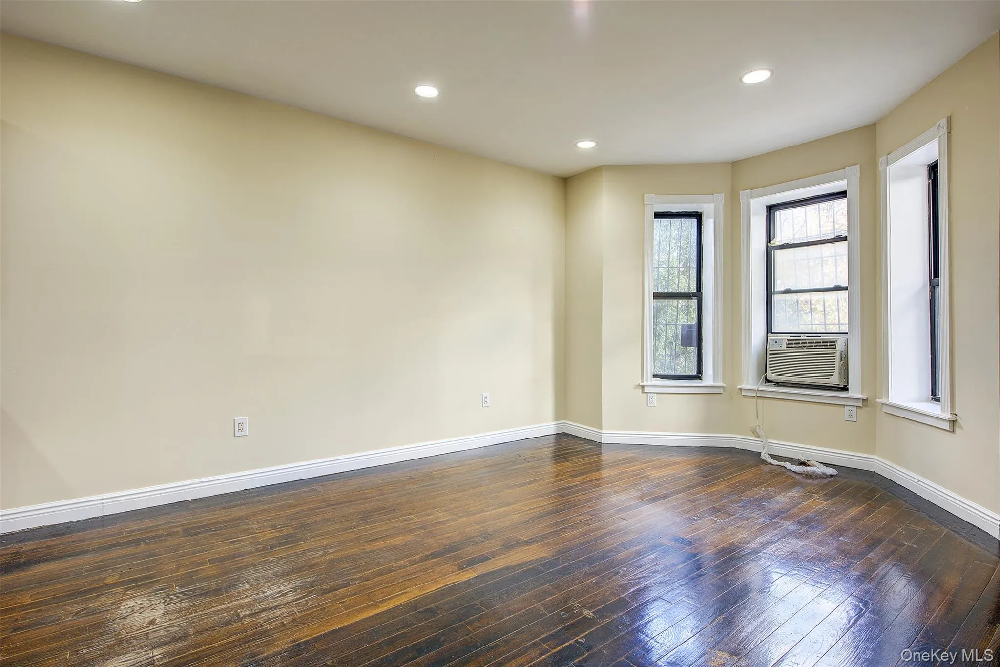 Unfurnished room with recessed lighting, dark wood-style flooring, and cooling unit Unfurnished room with recessed lighting, dark wood-style flooring, and cooling unit