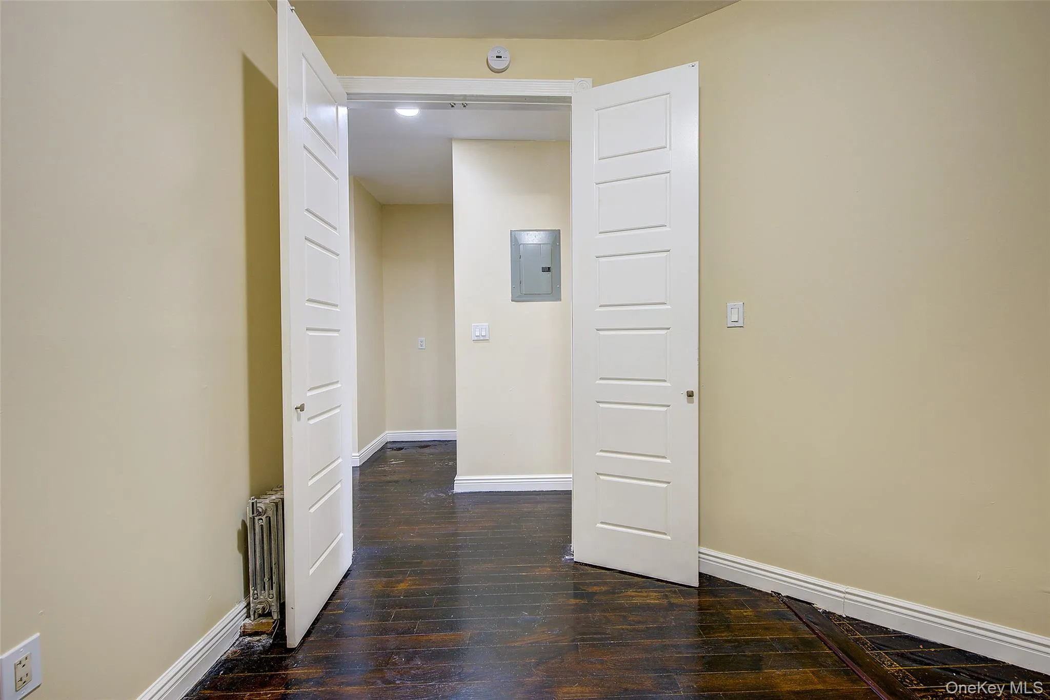 Hall featuring dark wood-style floors and electric panel Hall featuring dark wood-style floors and electric panel
