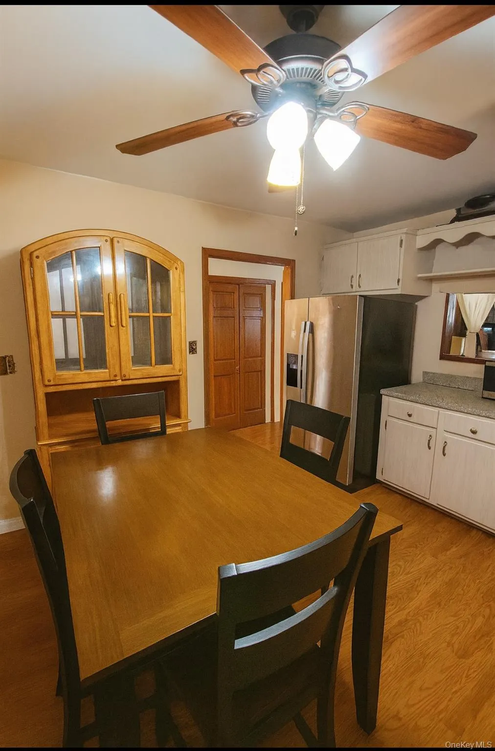 Dining space with light wood finished floors and ceiling fan Dining space with light wood finished floors and ceiling fan