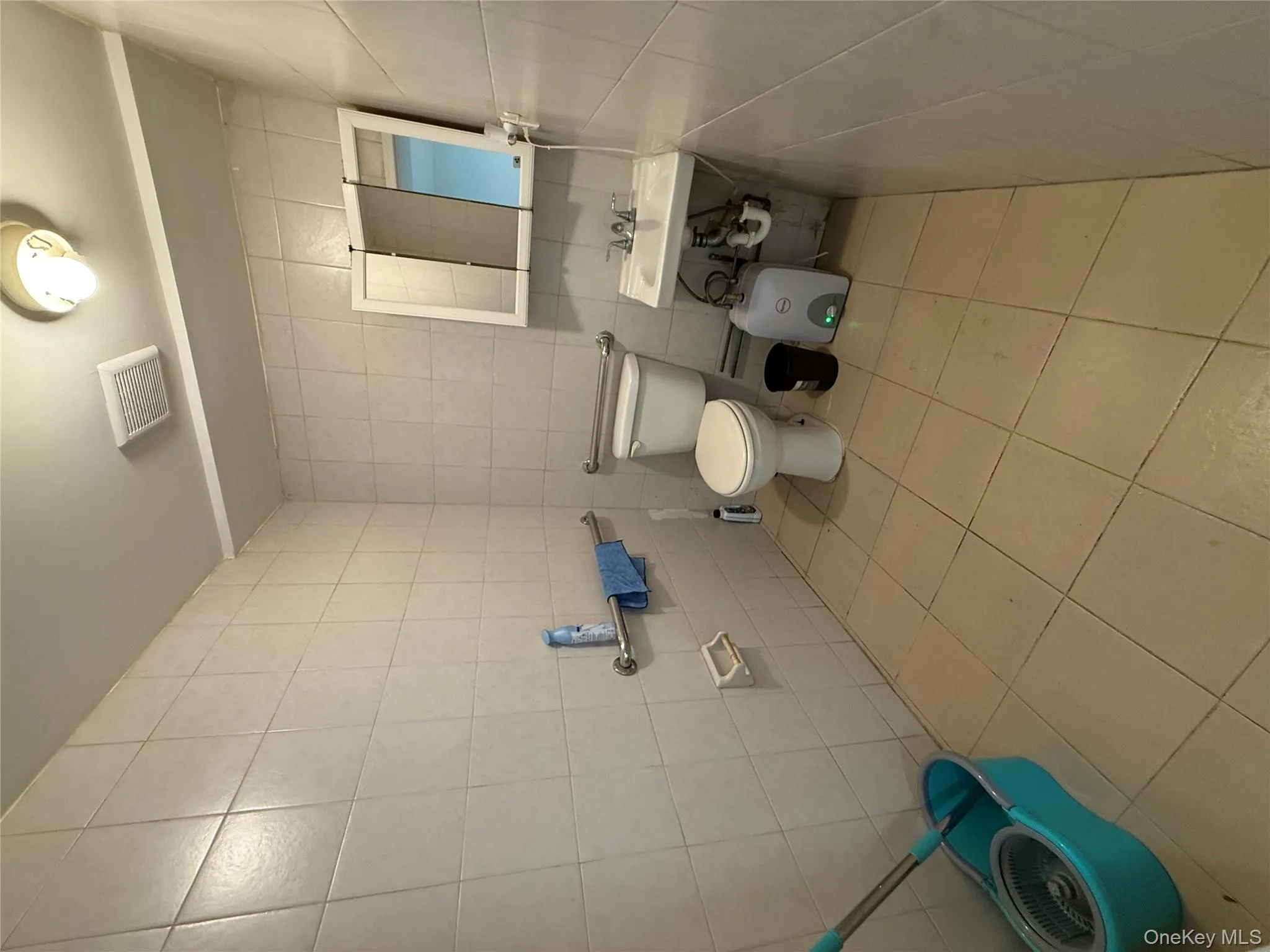 Half bath with tile walls and light tile patterned floors Half bath with tile walls and light tile patterned floors