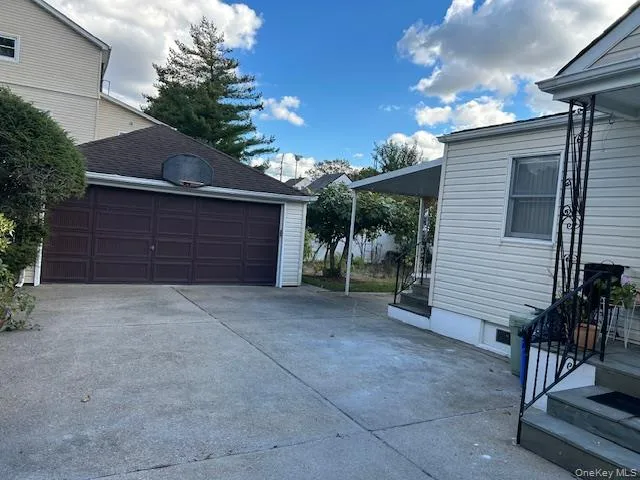 Garage featuring driveway Garage featuring driveway