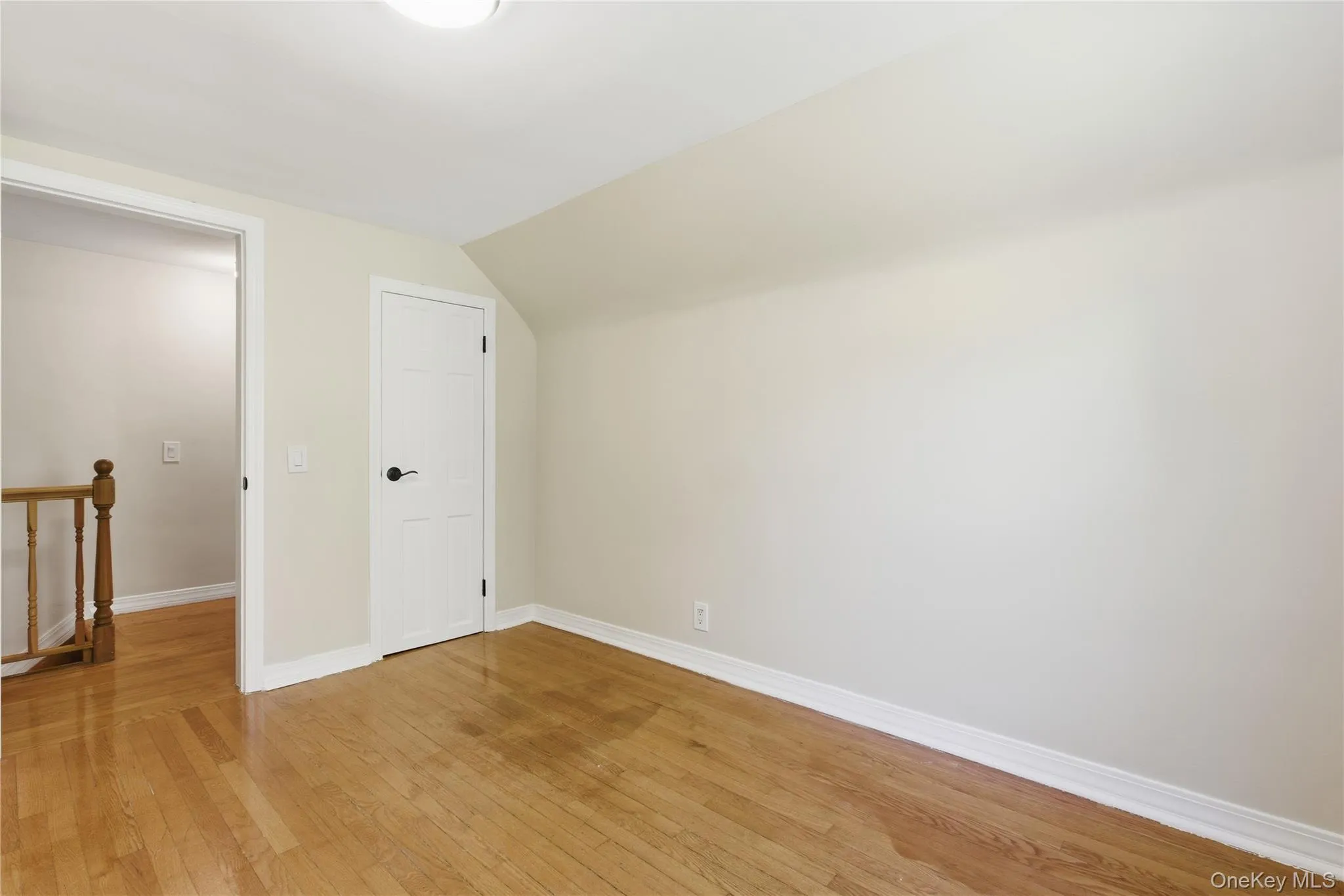 Additional living space featuring light wood-type flooring and lofted ceiling Additional living space featuring light wood-type flooring and lofted ceiling