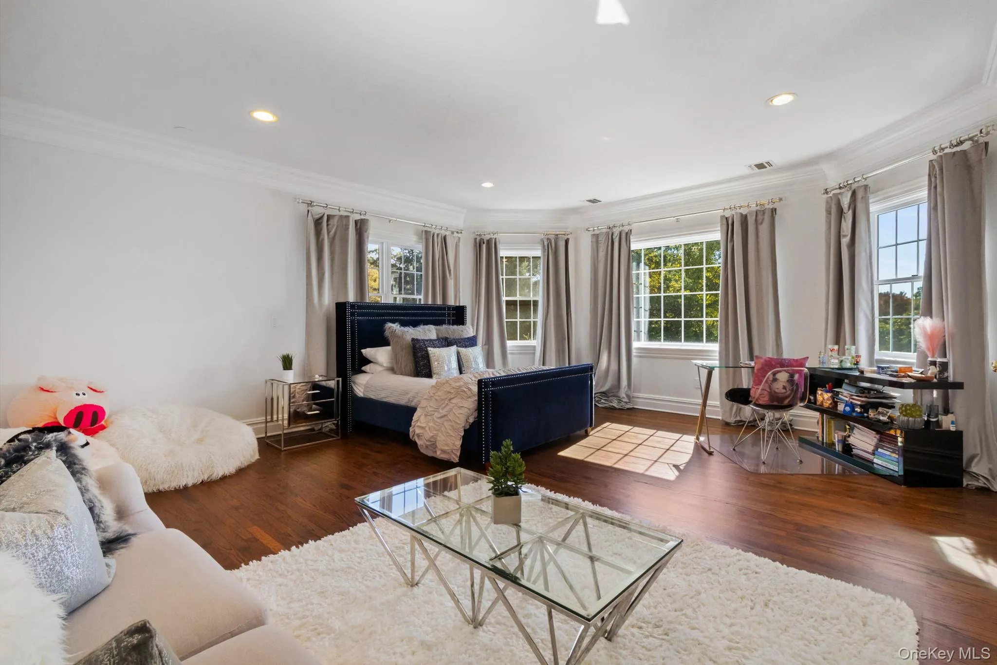 Bedroom with ornamental molding, wood finished floors, multiple windows, and recessed lighting Bedroom with ornamental molding, wood finished floors, multiple windows, and recessed lighting