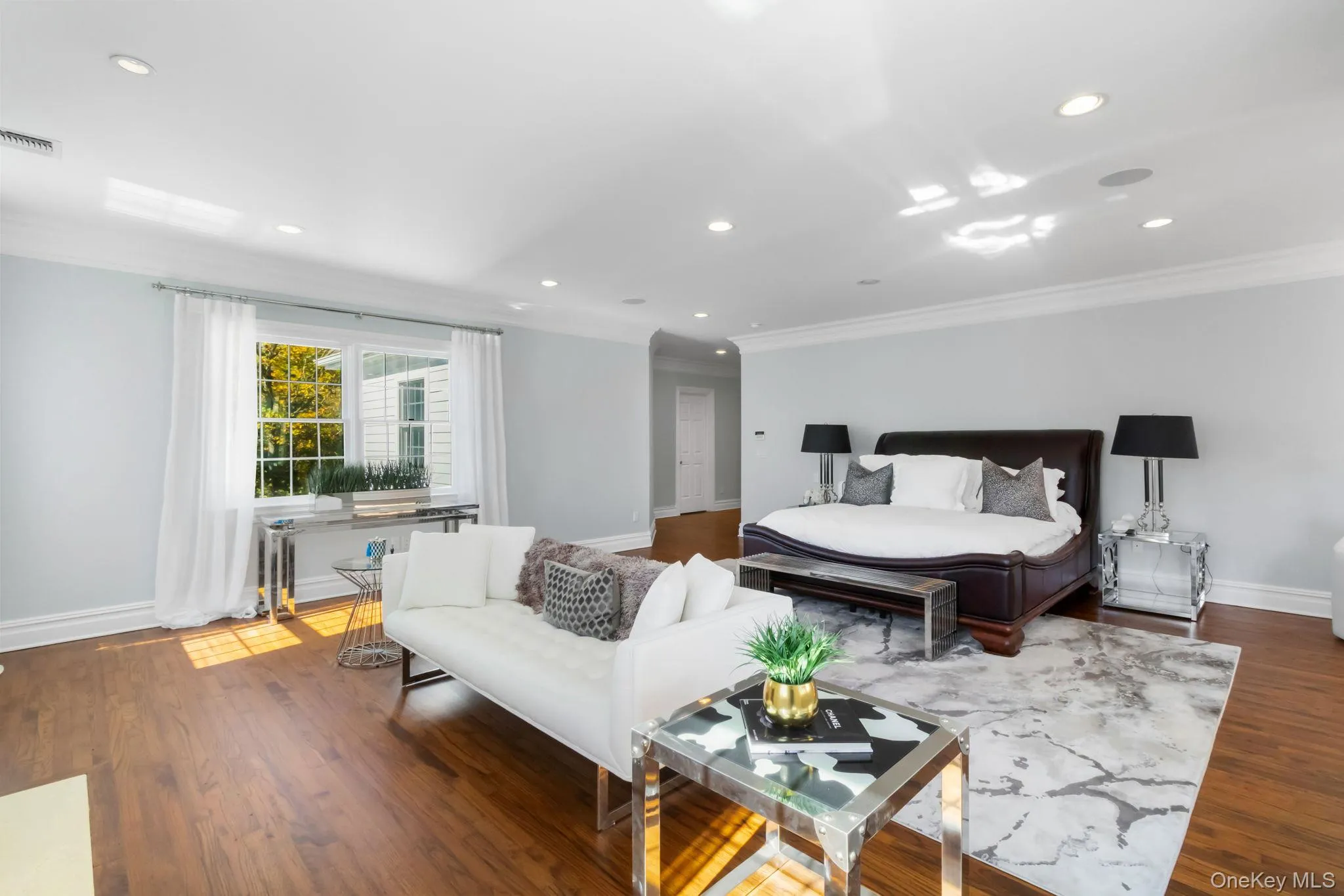 Bedroom featuring crown molding, recessed lighting, and dark wood finished floors Bedroom featuring crown molding, recessed lighting, and dark wood finished floors