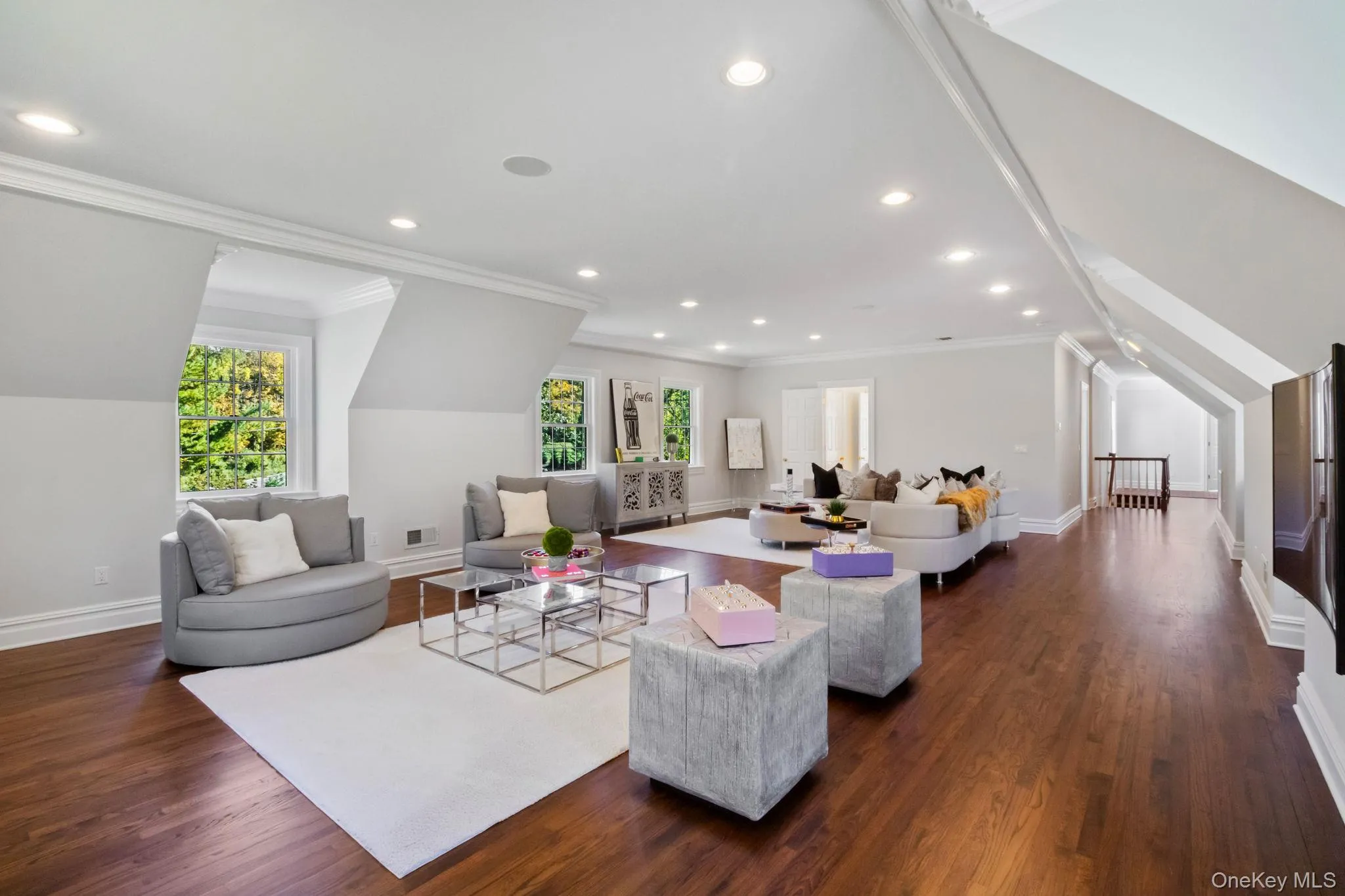 Living room with ornamental molding, dark wood-style flooring, and recessed lighting Living room with ornamental molding, dark wood-style flooring, and recessed lighting
