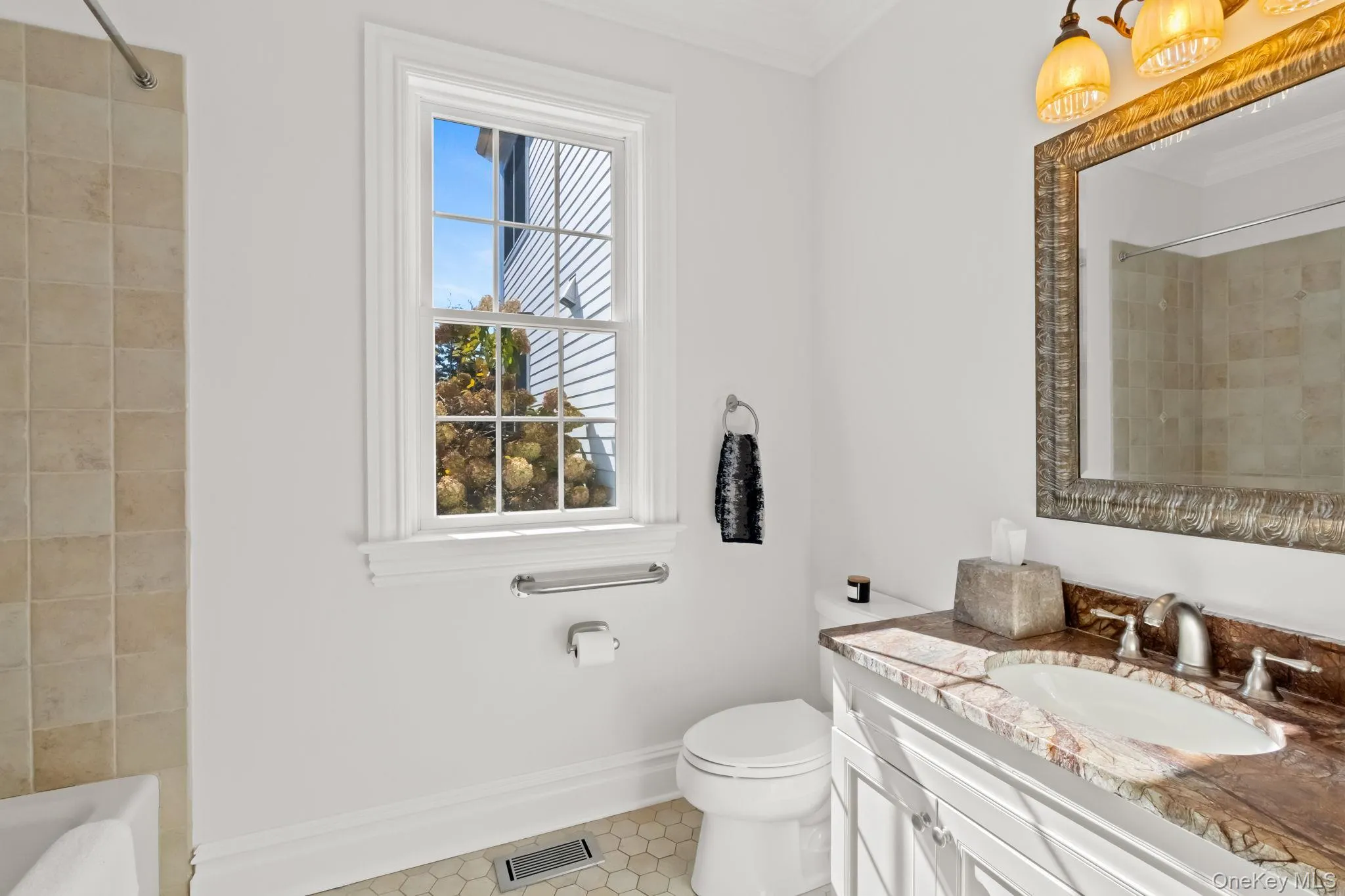 Full bath with vanity, ornamental molding, light tile patterned floors, and tiled shower / bath Full bath with vanity, ornamental molding, light tile patterned floors, and tiled shower / bath