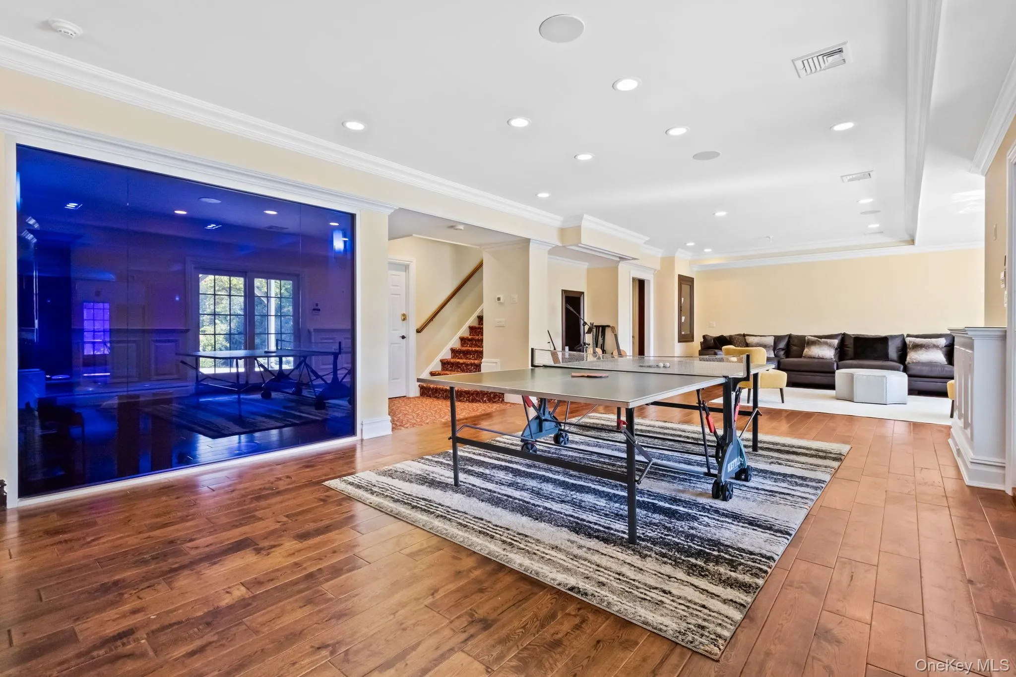 Recreation room with crown molding, hardwood / wood-style floors, and recessed lighting Recreation room with crown molding, hardwood / wood-style floors, and recessed lighting