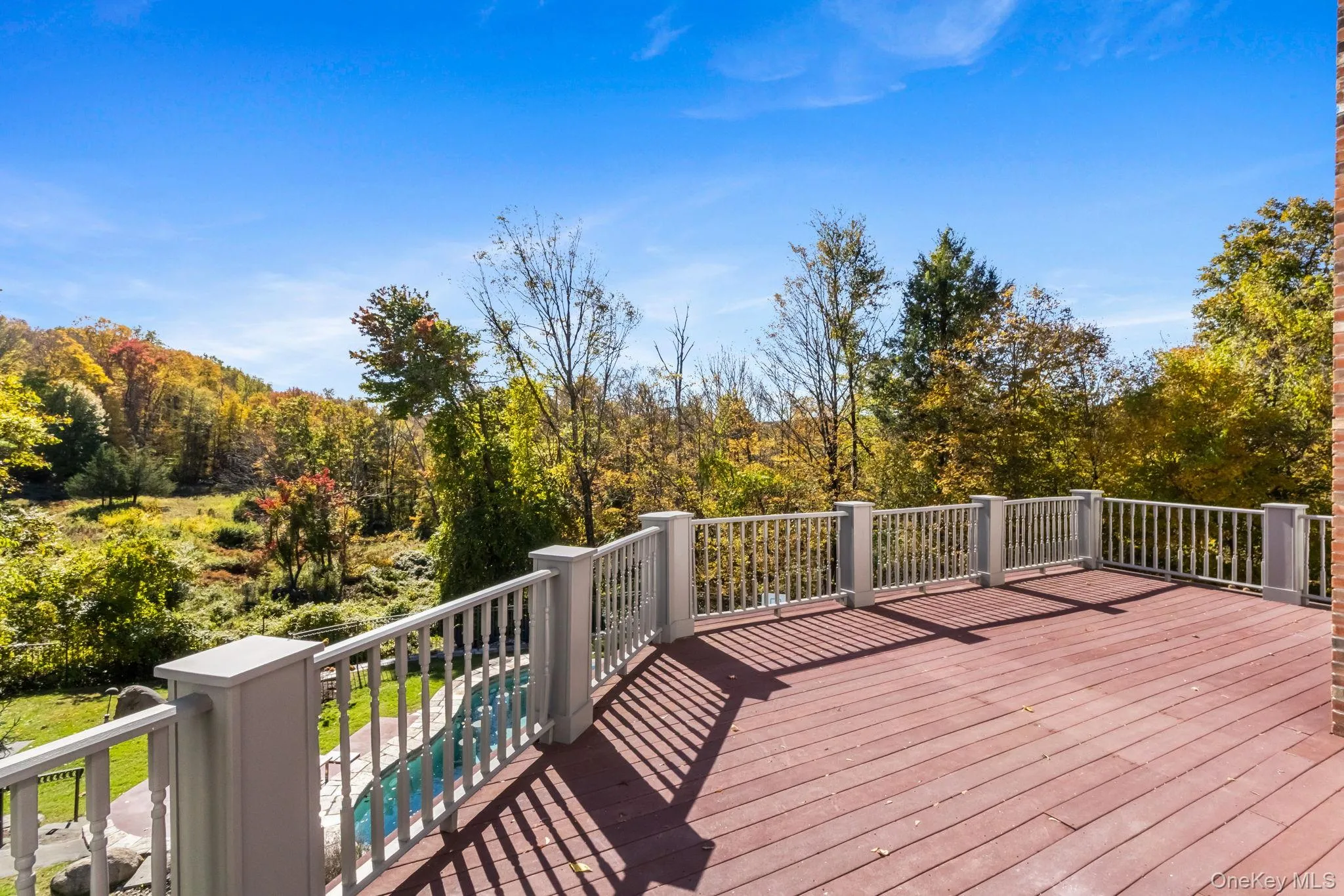 Wooden deck with an outdoor pool below Wooden deck with an outdoor pool below