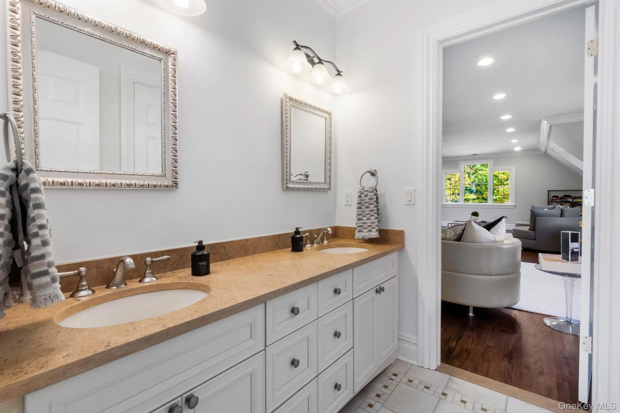 Full bath with ornamental molding, double vanity, recessed lighting, and light tile patterned flooring Full bath with ornamental molding, double vanity, recessed lighting, and light tile patterned flooring