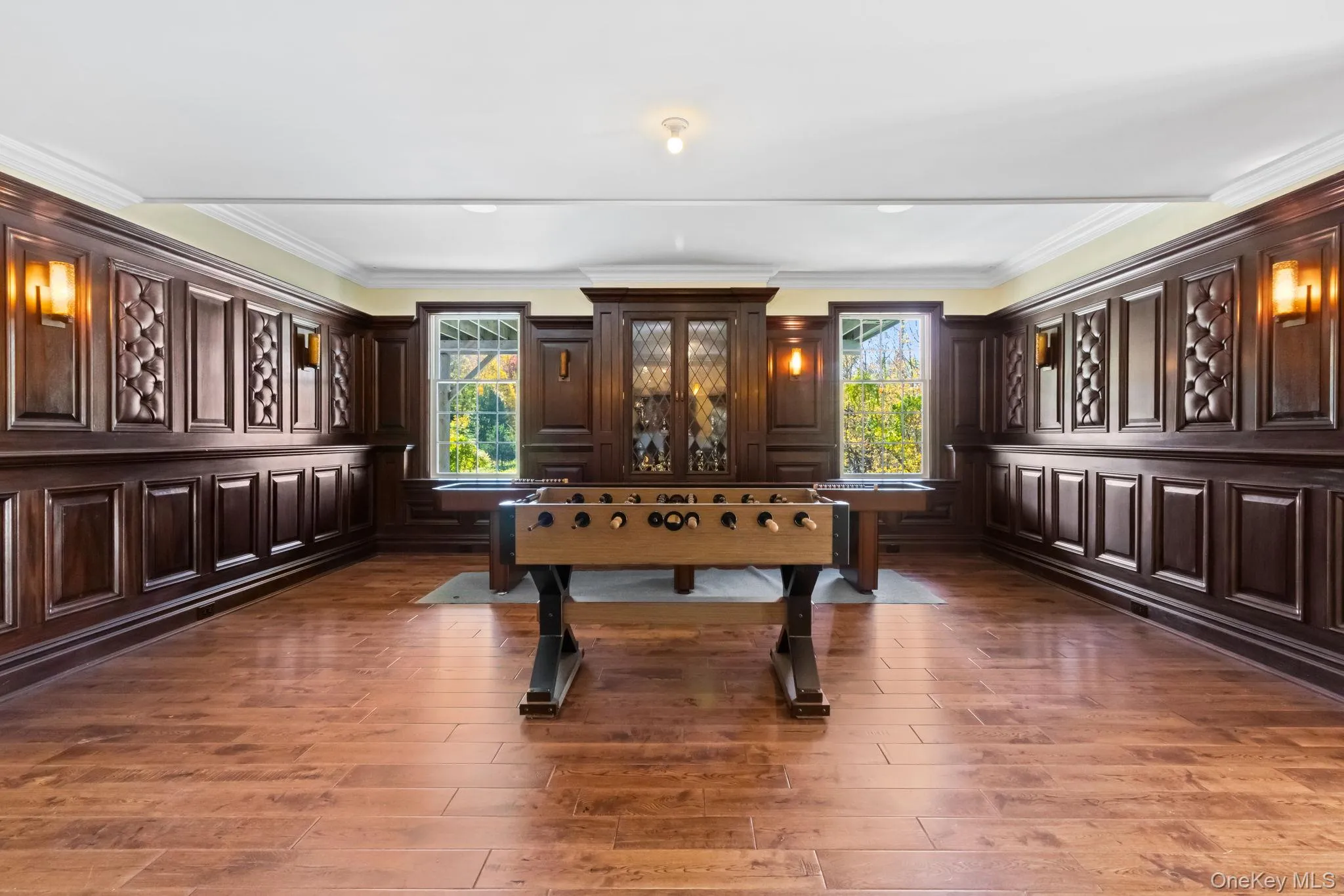 Playroom with ornamental molding, plenty of natural light, and dark wood finished floors Playroom with ornamental molding, plenty of natural light, and dark wood finished floors