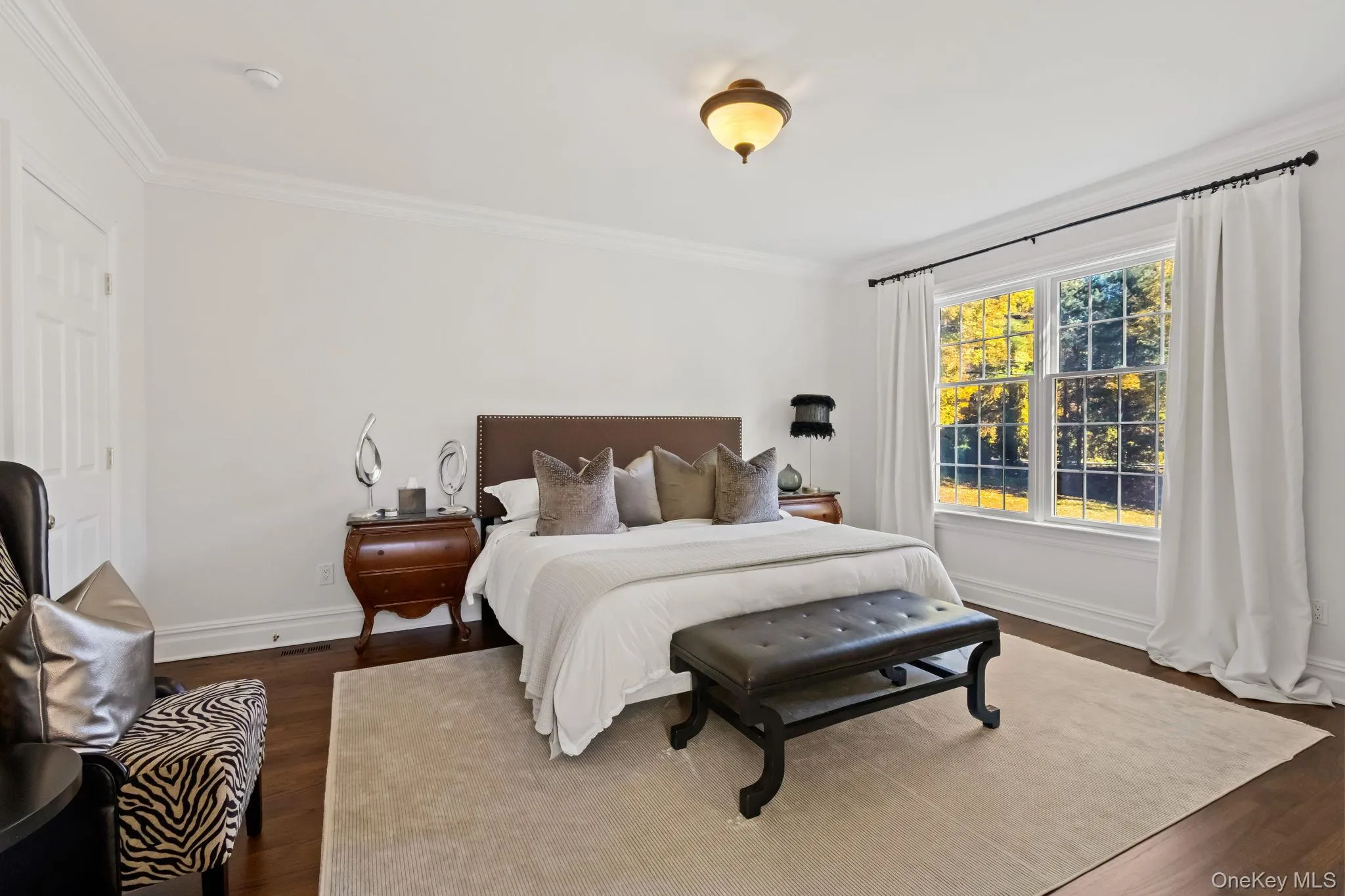 Bedroom with dark wood-style floors and crown molding Bedroom with dark wood-style floors and crown molding