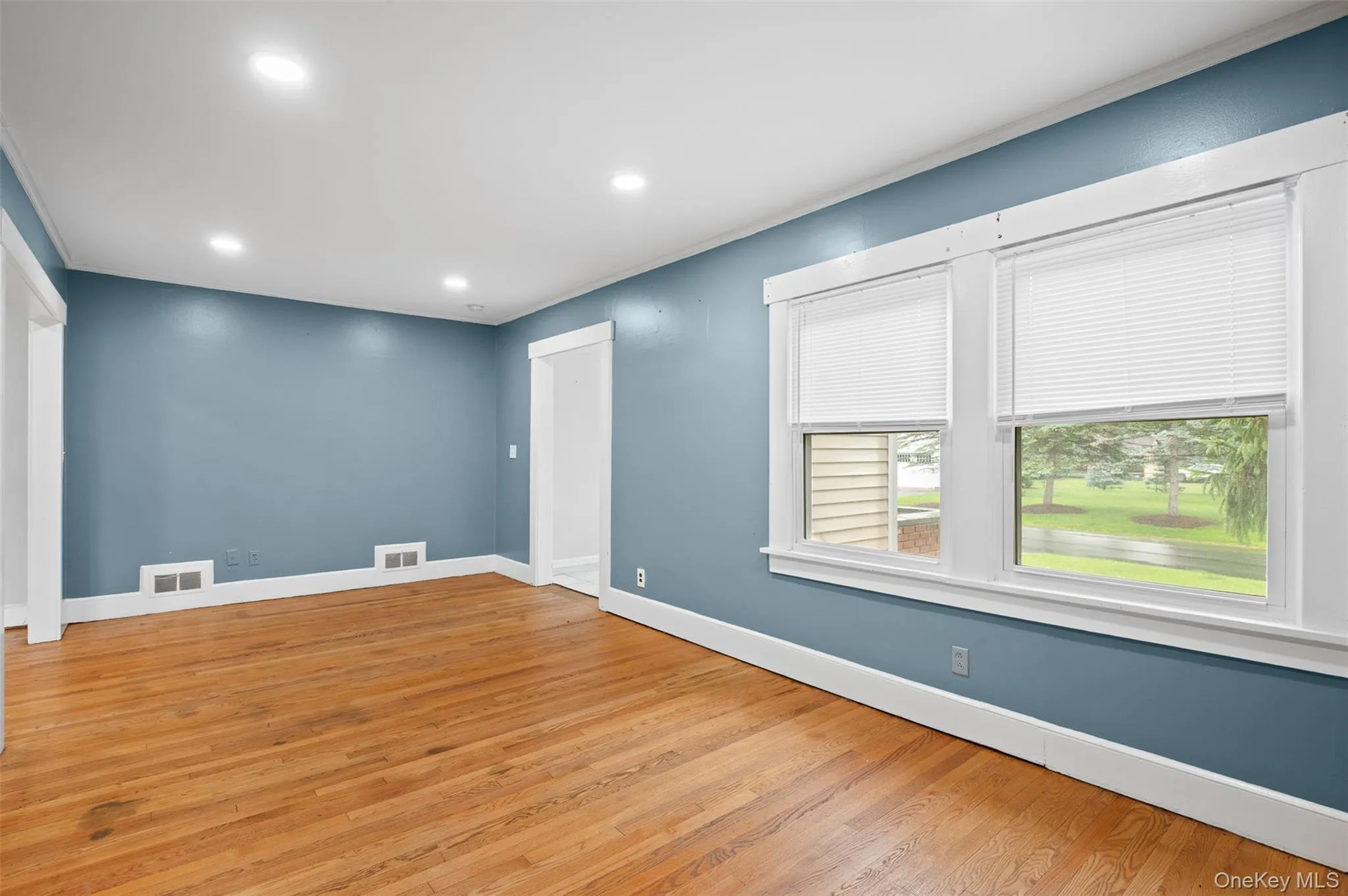 Unfurnished room featuring light wood finished floors and recessed lighting Unfurnished room featuring light wood finished floors and recessed lighting