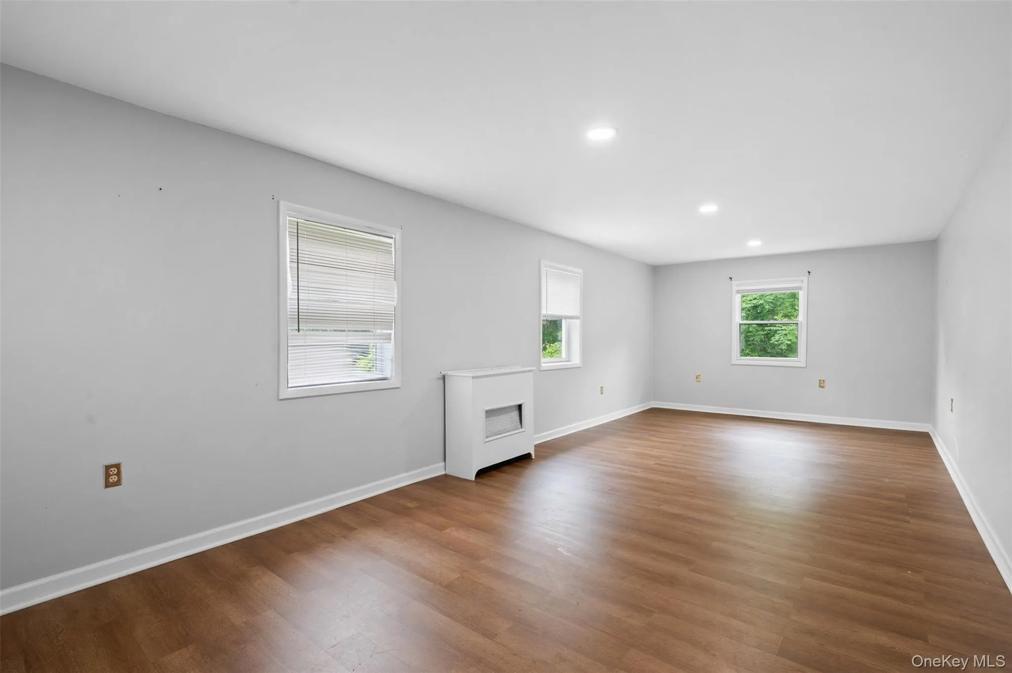 Spare room with dark wood-style floors and recessed lighting Spare room with dark wood-style floors and recessed lighting