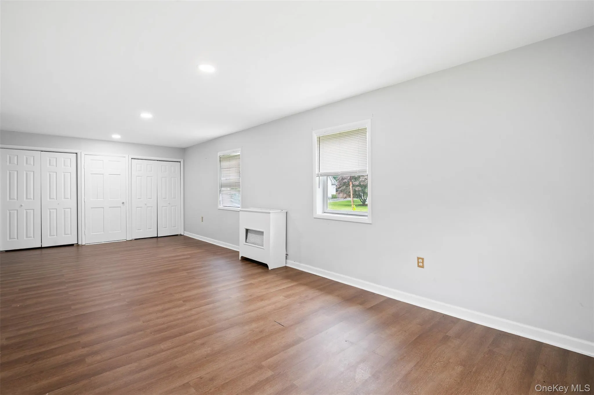 Unfurnished living room with wood finished floors and recessed lighting Unfurnished living room with wood finished floors and recessed lighting