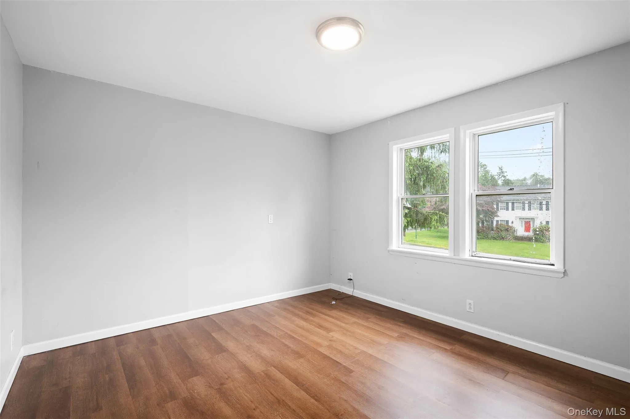 Empty room featuring baseboards and wood finished floors Empty room featuring baseboards and wood finished floors