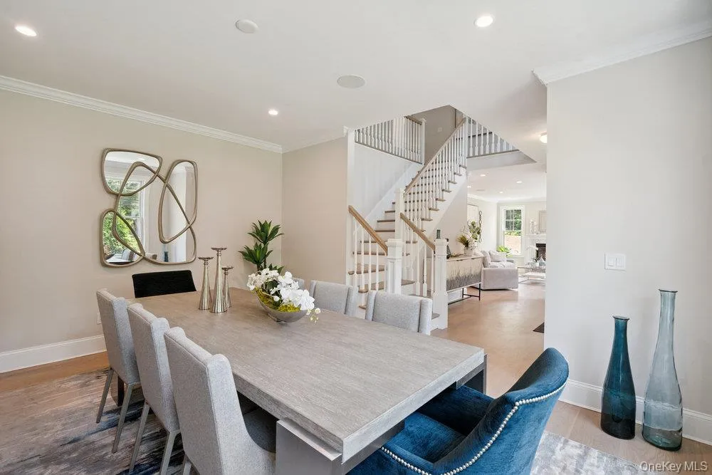 Dining area featuring crown molding, recessed lighting, stairway, and light wood-type flooring Dining area featuring crown molding, recessed lighting, stairway, and light wood-type flooring
