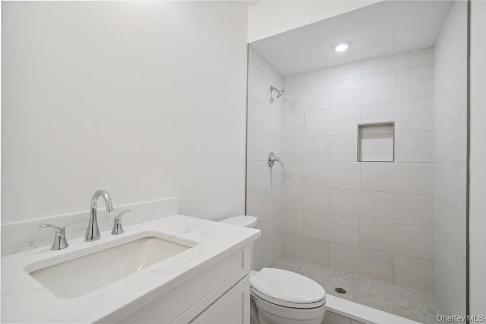 Full bath featuring vanity, a shower stall, and recessed lighting Full bath featuring vanity, a shower stall, and recessed lighting