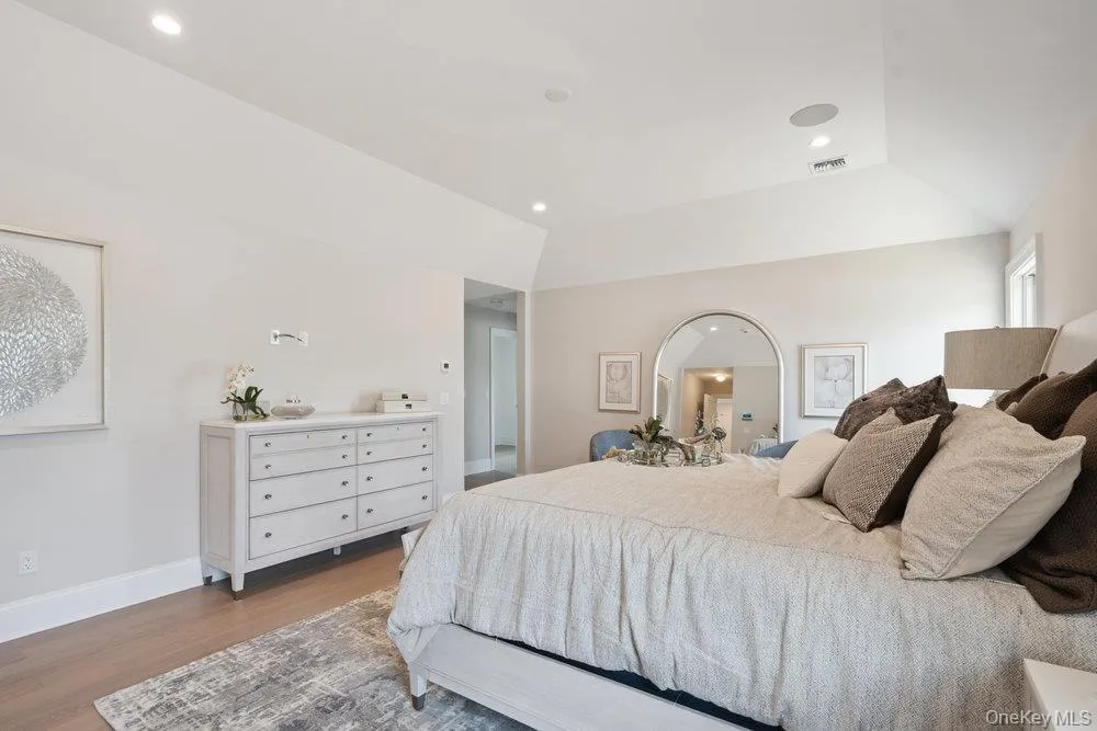 Bedroom with wood finished floors and recessed lighting Bedroom with wood finished floors and recessed lighting
