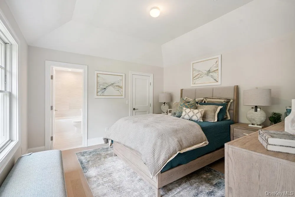 Bedroom featuring wood finished floors and baseboards Bedroom featuring wood finished floors and baseboards
