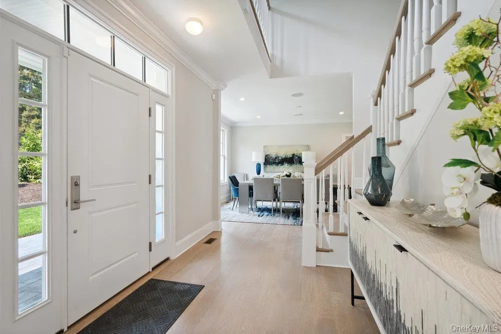 Entryway featuring crown molding, light wood-style flooring, stairway, and recessed lighting Entryway featuring crown molding, light wood-style flooring, stairway, and recessed lighting
