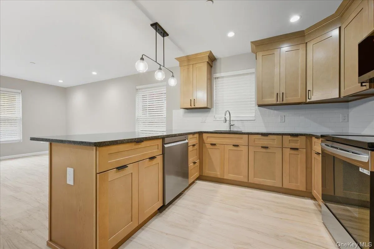 Kitchen with New Stainless Steel Appliances Including Electric Range, Microwave and Dishwasher Kitchen with New Stainless Steel Appliances Including Electric Range, Microwave and Dishwasher