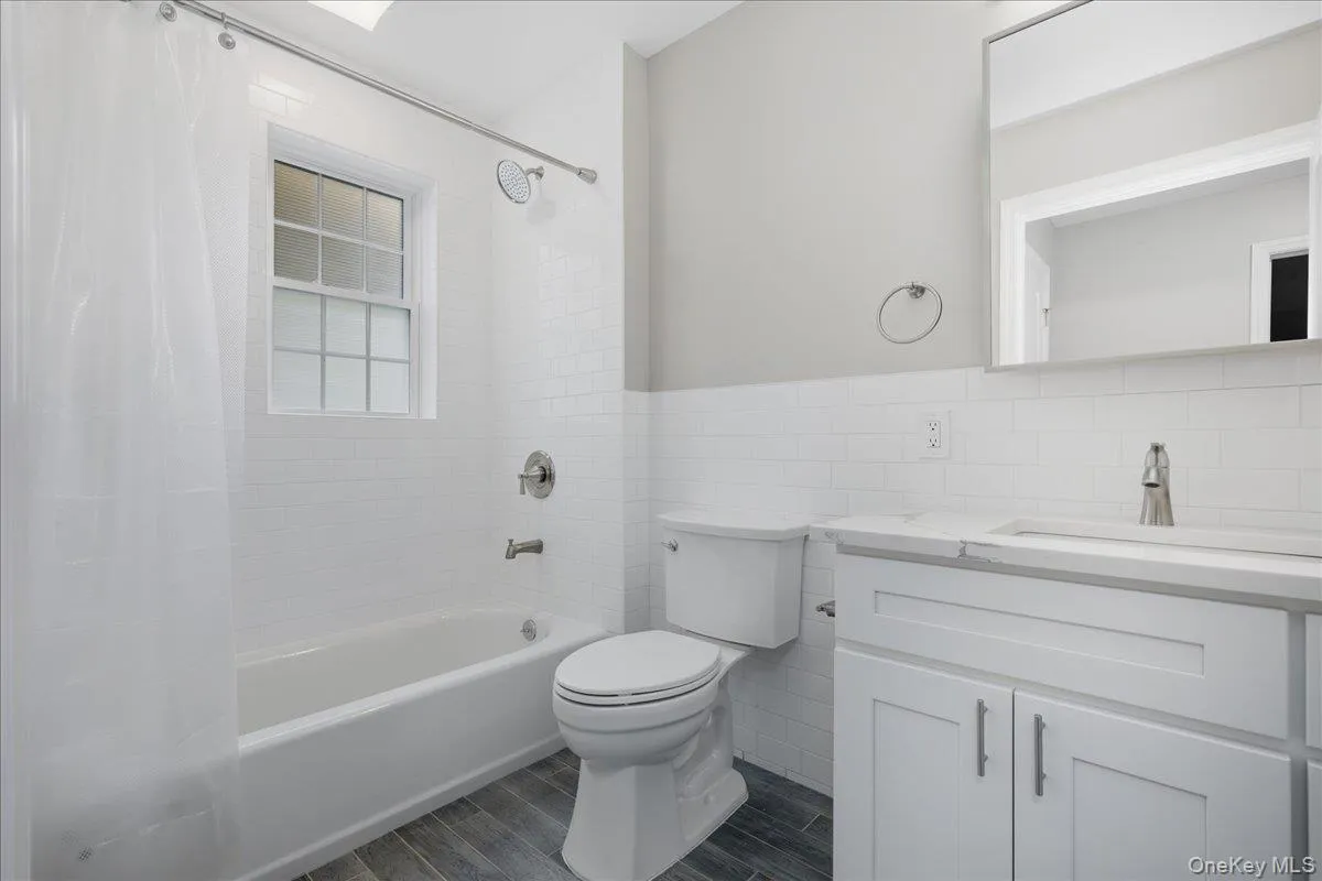 Full Bath with White Vanity, Subway Tile Walls, Shower/Tub Combo & Luxury Vinyl Plank Floors Full Bath with White Vanity, Subway Tile Walls, Shower/Tub Combo & Luxury Vinyl Plank Floors