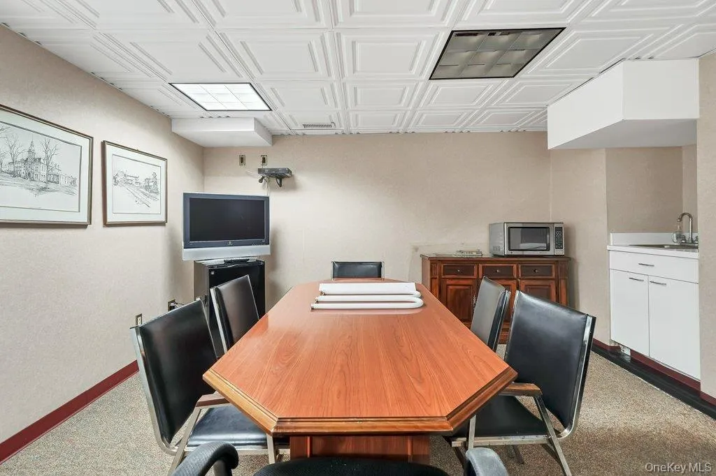 Home office with an ornate ceiling and dark carpet Home office with an ornate ceiling and dark carpet
