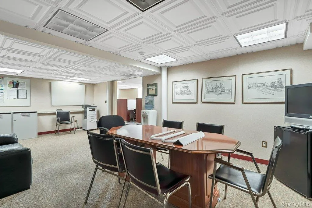 Home office with an ornate ceiling and light colored carpet Home office with an ornate ceiling and light colored carpet