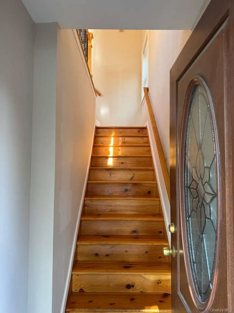 Stairway featuring baseboards Stairway featuring baseboards