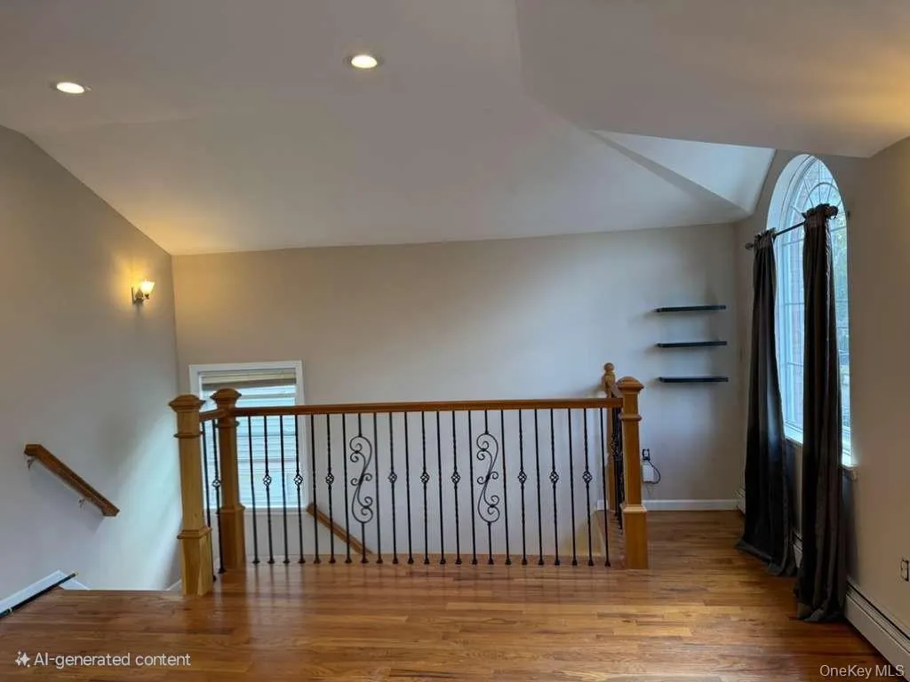 Bonus room with light wood-style flooring, lofted ceiling, recessed lighting, and baseboard heating Bonus room with light wood-style flooring, lofted ceiling, recessed lighting, and baseboard heating