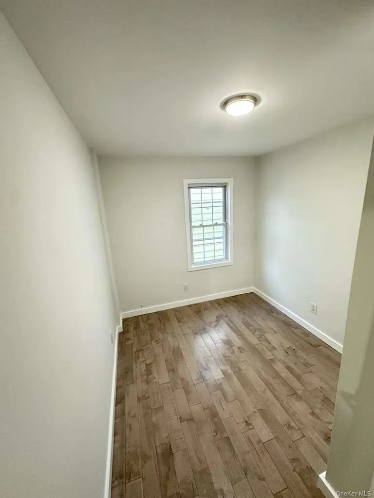 Unfurnished room featuring light wood-style floors and baseboards Unfurnished room featuring light wood-style floors and baseboards