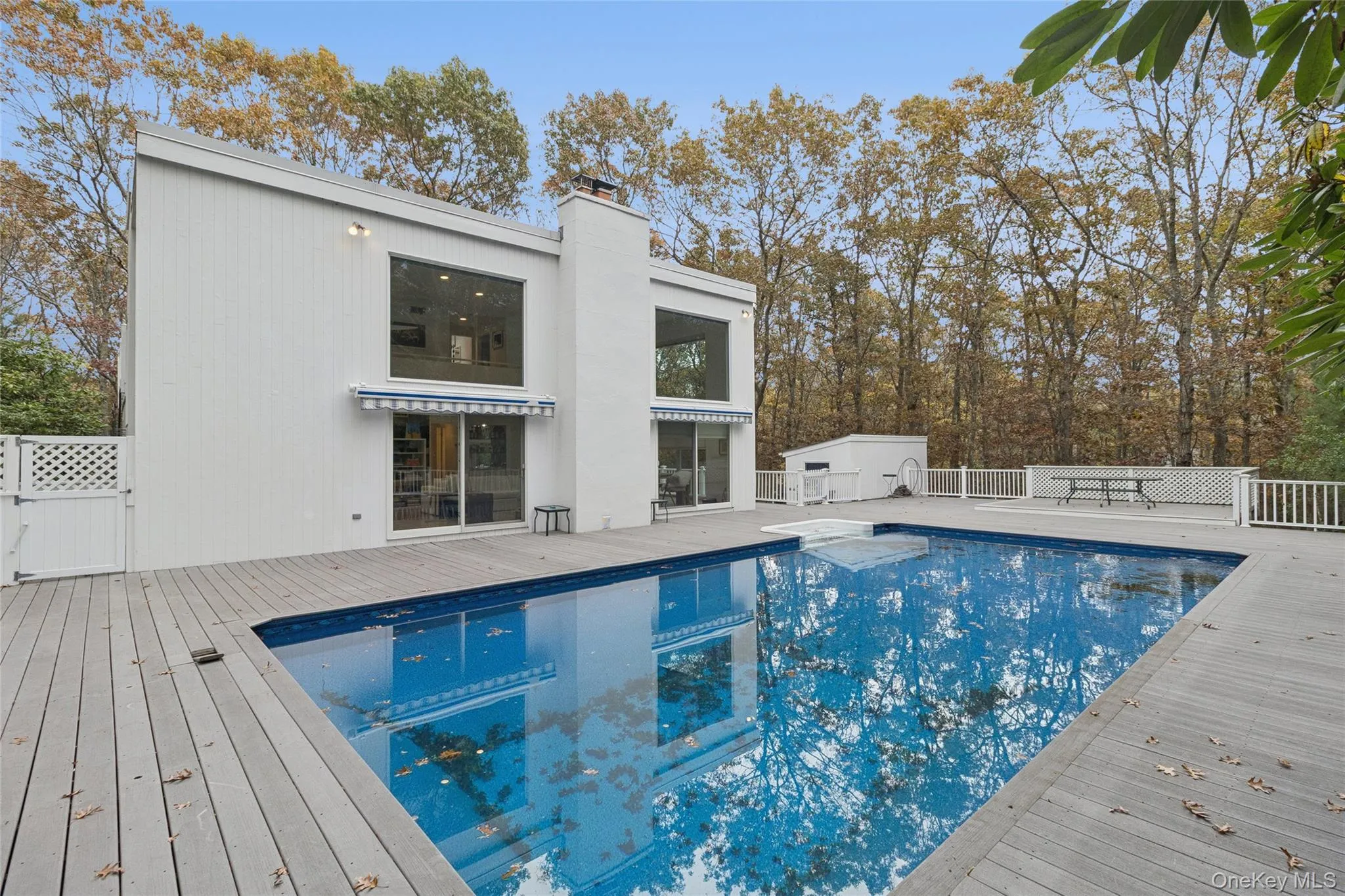 View of swimming pool with a wooden deck and an outdoor structure View of swimming pool with a wooden deck and an outdoor structure