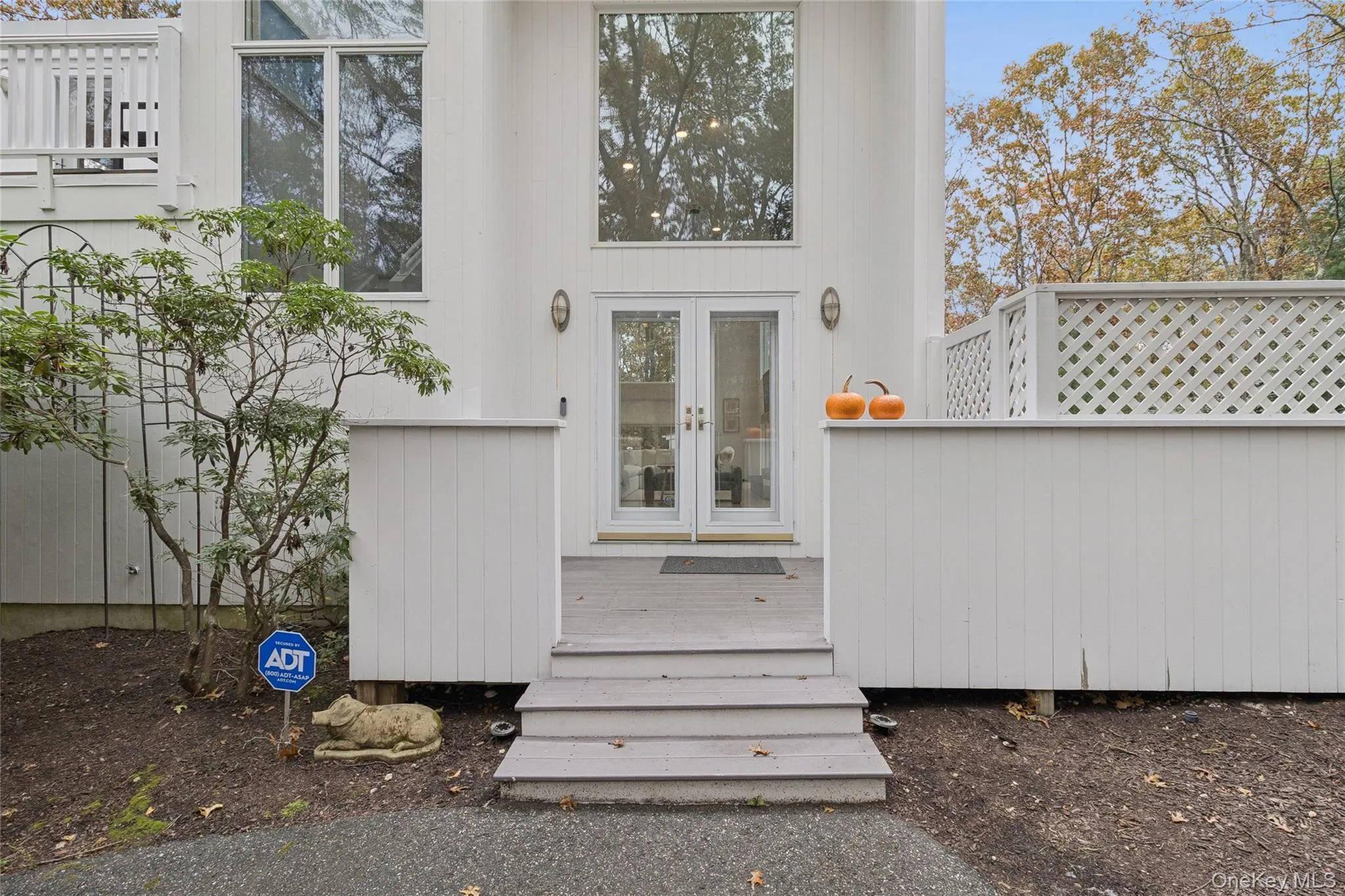 View of exterior entry featuring french doors and a wooden deck View of exterior entry featuring french doors and a wooden deck