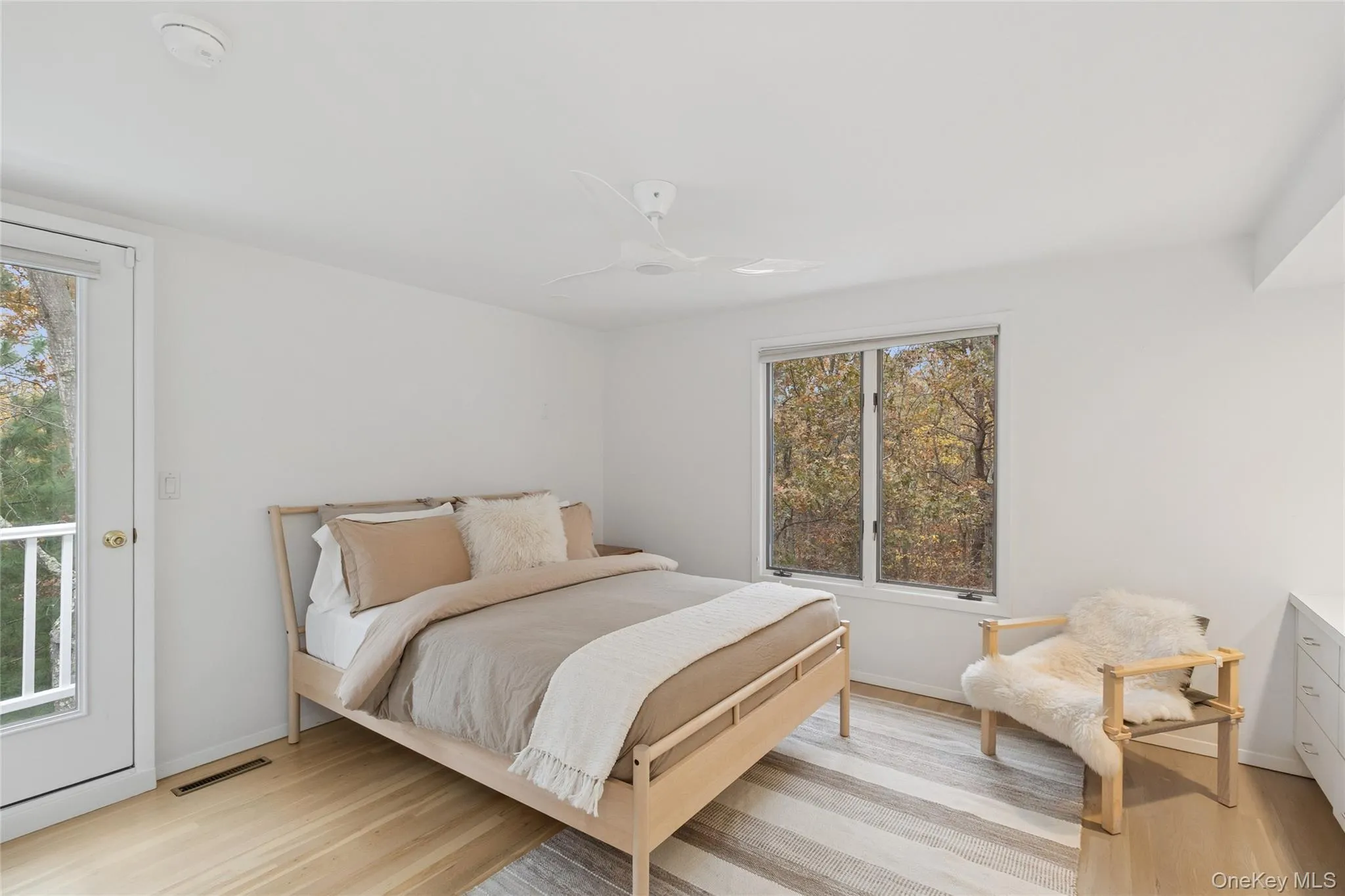 Bedroom featuring a ceiling fan and light wood-style floors Bedroom featuring a ceiling fan and light wood-style floors