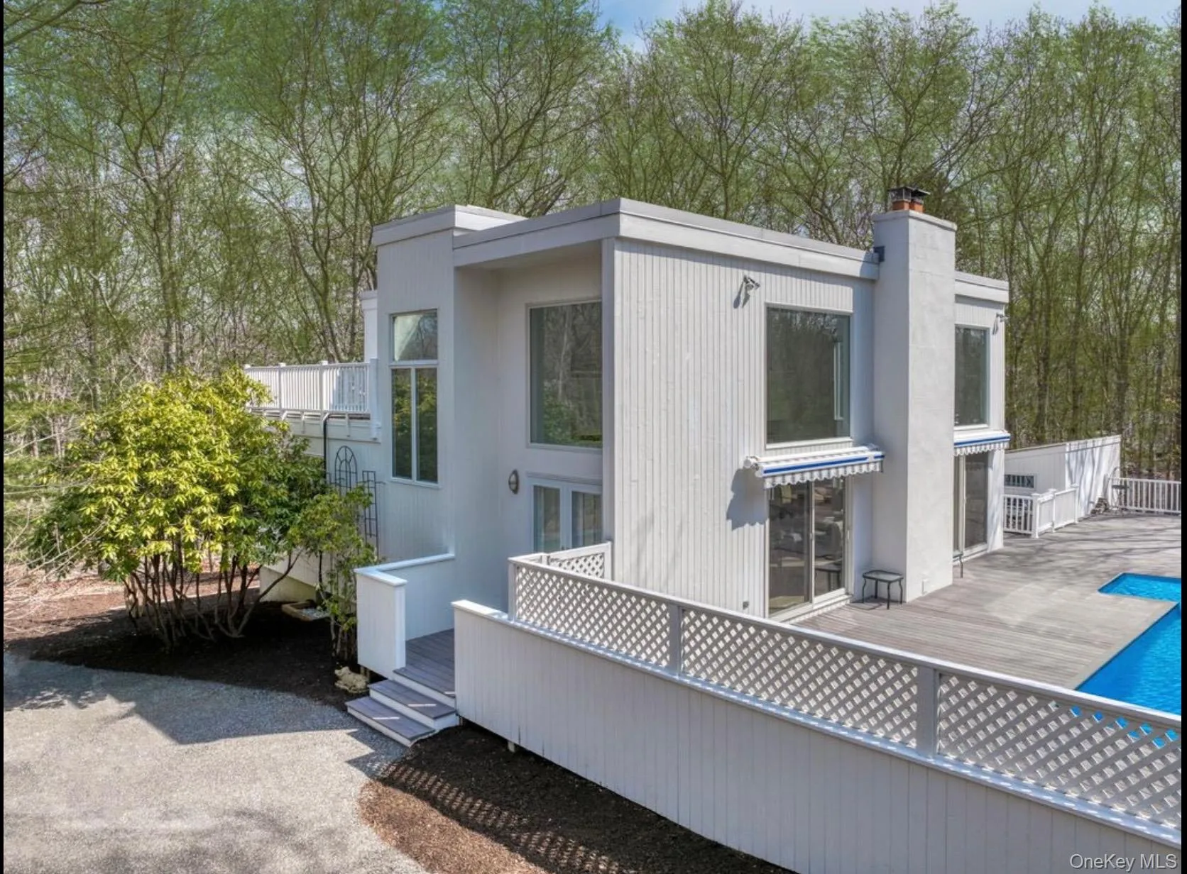 Back of house with a deck and a chimney Back of house with a deck and a chimney