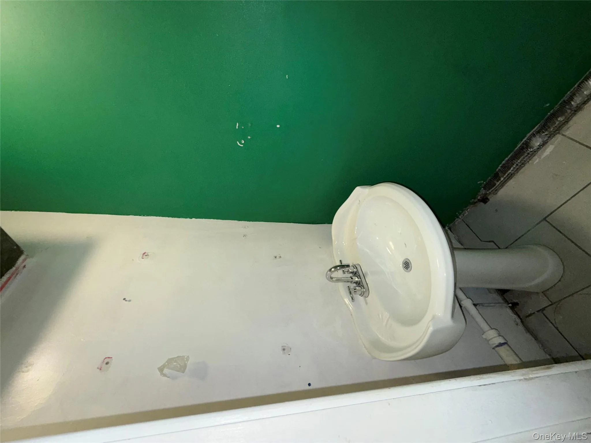 Bathroom with tile patterned flooring and a sink Bathroom with tile patterned flooring and a sink