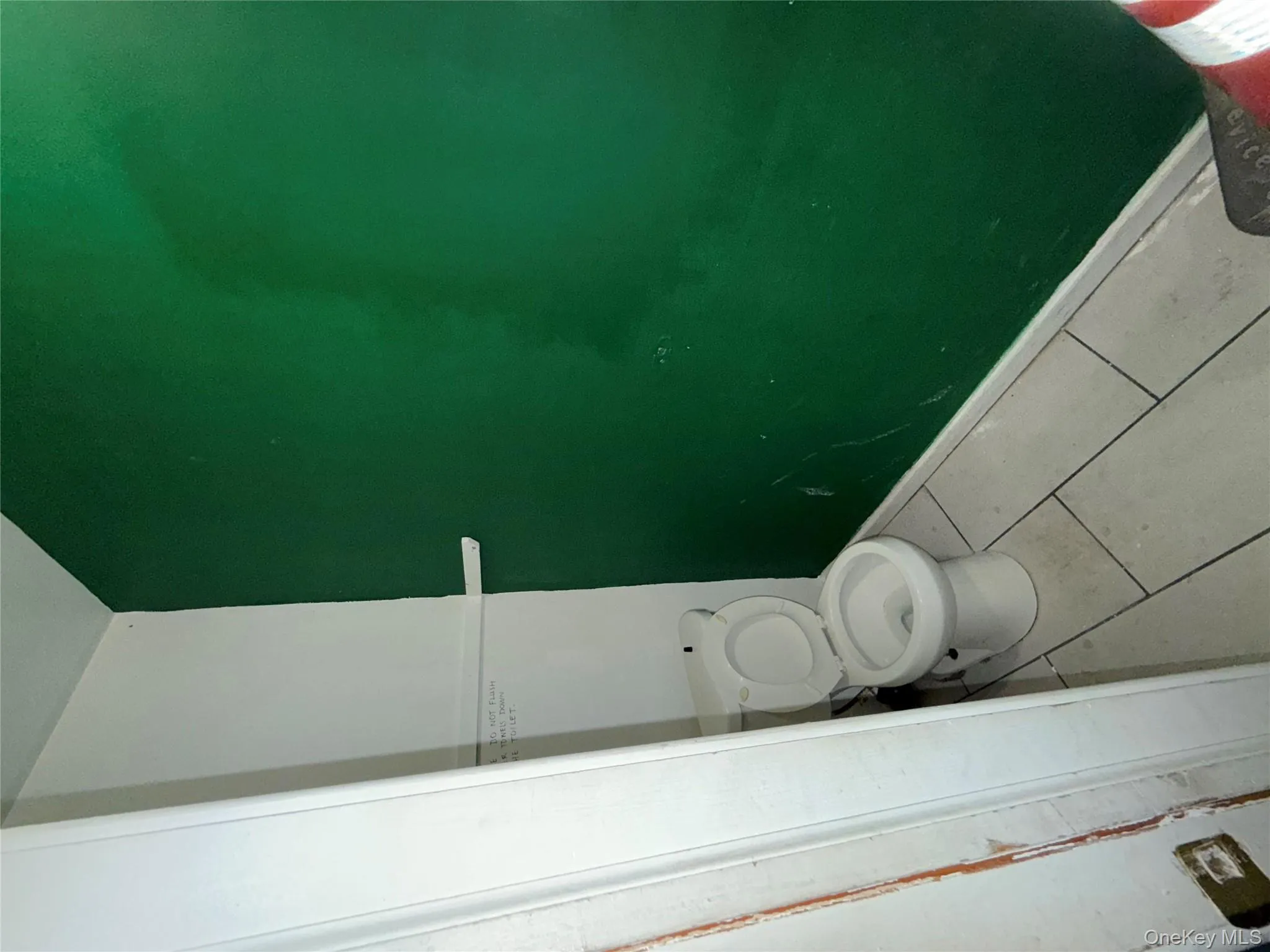 Bathroom with tile patterned flooring and toilet Bathroom with tile patterned flooring and toilet