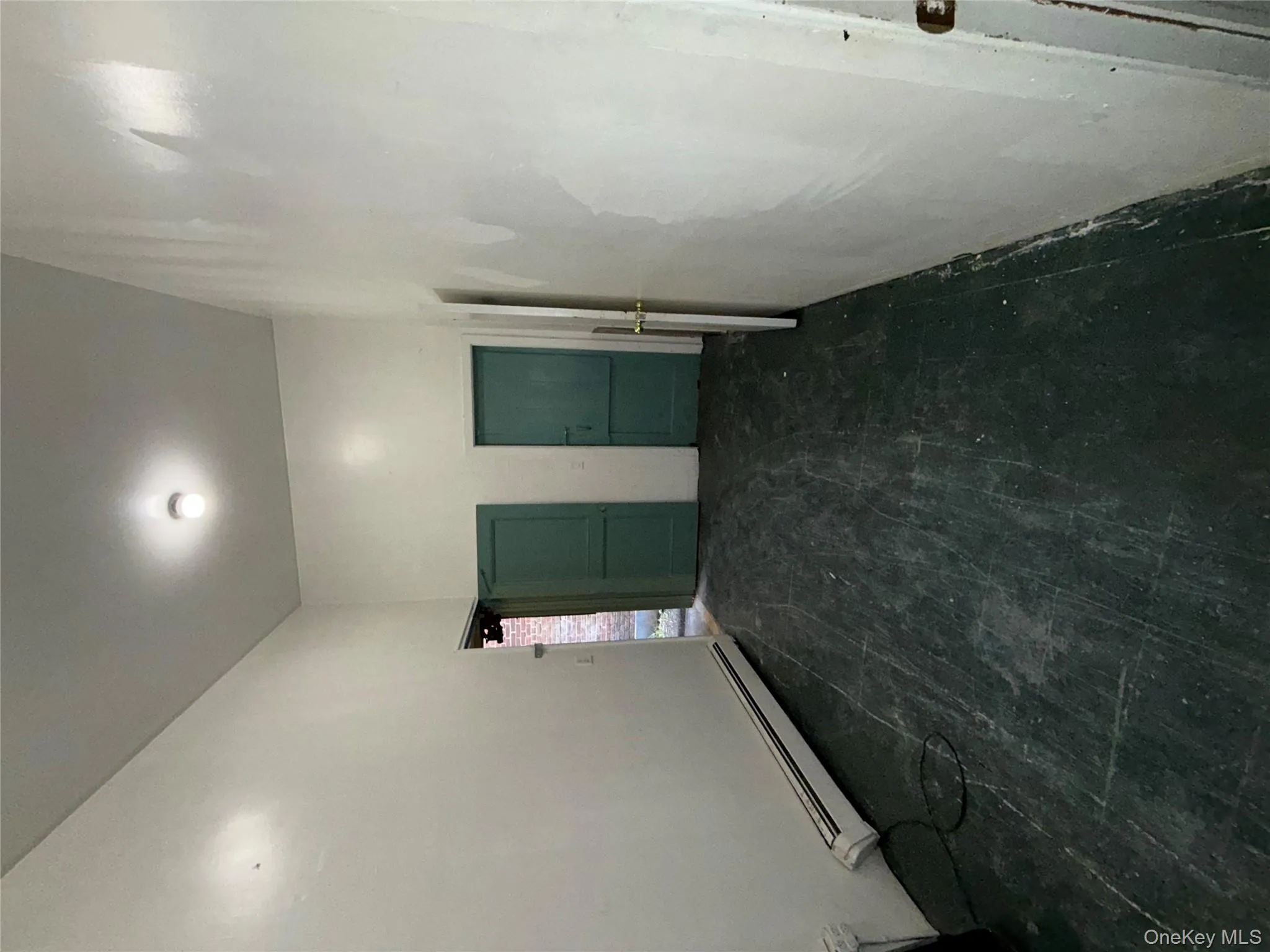 Empty room with baseboard heating Empty room with baseboard heating