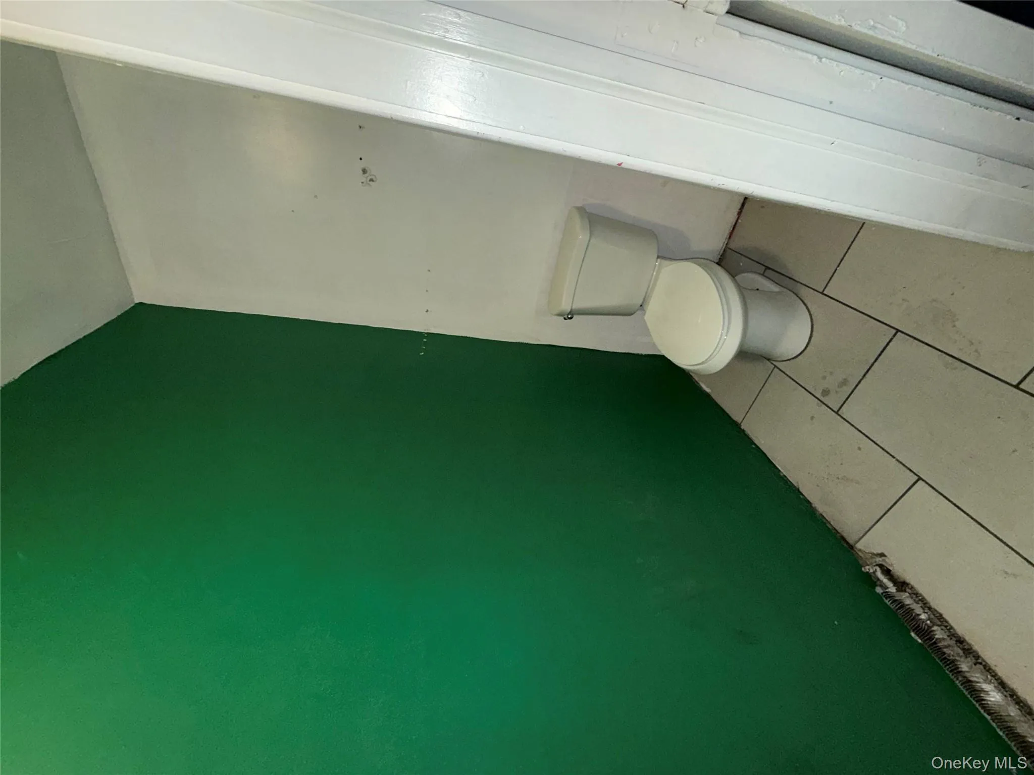 Bathroom with tile patterned floors and toilet Bathroom with tile patterned floors and toilet