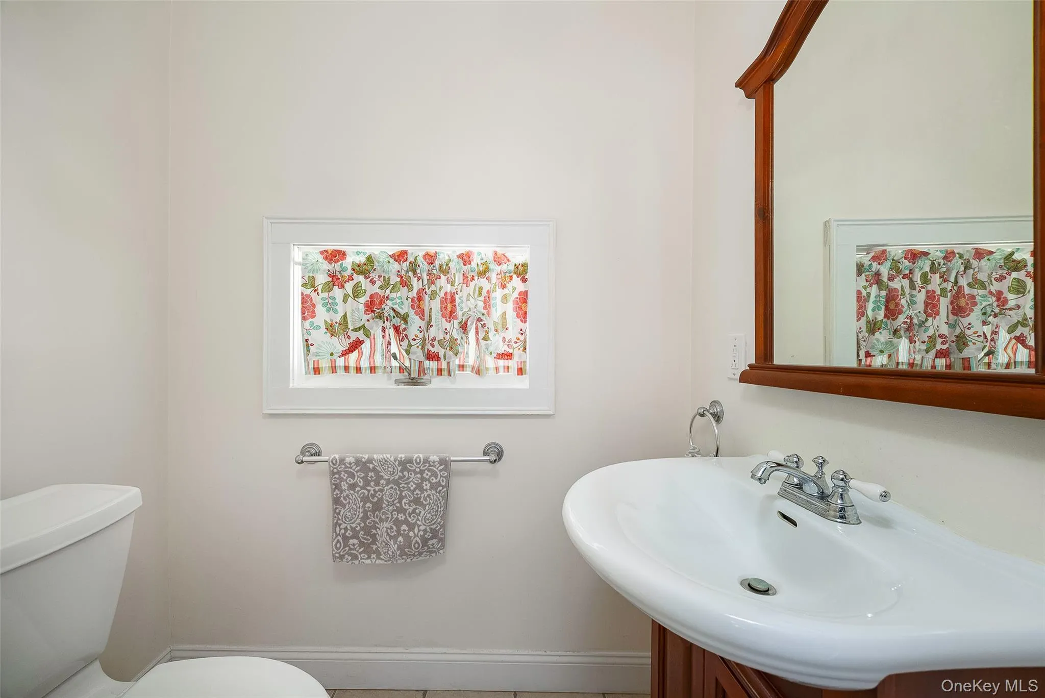 Half bath featuring vanity and tile patterned flooring Half bath featuring vanity and tile patterned flooring