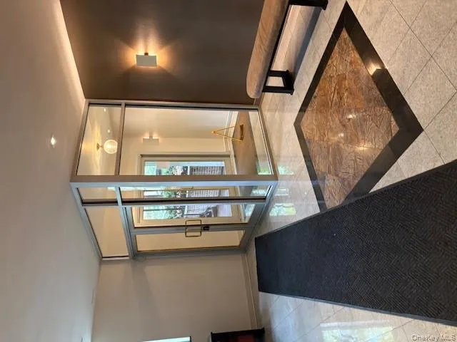 Lobby featuring a wall of windows and recessed lighting Lobby featuring a wall of windows and recessed lighting