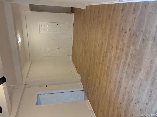 Empty room with light wood-style floors, beam ceiling, and ceiling fan Empty room with light wood-style floors, beam ceiling, and ceiling fan