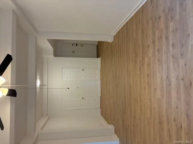 Spare room featuring beamed ceiling, light wood-type flooring, and a ceiling fan Spare room featuring beamed ceiling, light wood-type flooring, and a ceiling fan