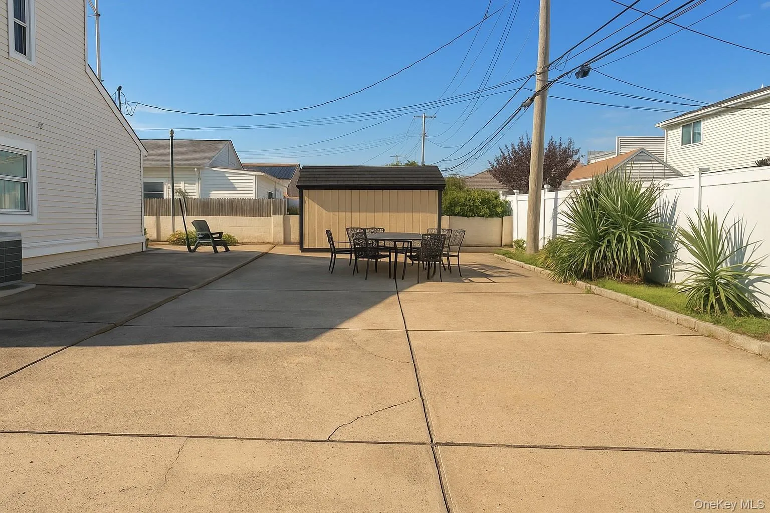 Fenced backyard with outdoor dining space, a storage shed, and a patio area Fenced backyard with outdoor dining space, a storage shed, and a patio area