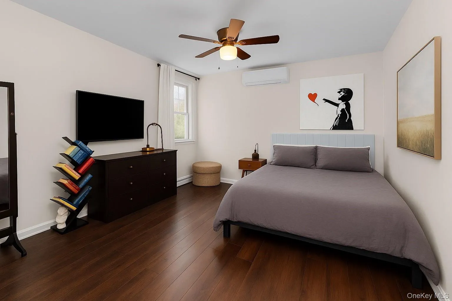 Bedroom with dark wood-type flooring, ceiling fan, and a wall mounted air conditioner Bedroom with dark wood-type flooring, ceiling fan, and a wall mounted air conditioner