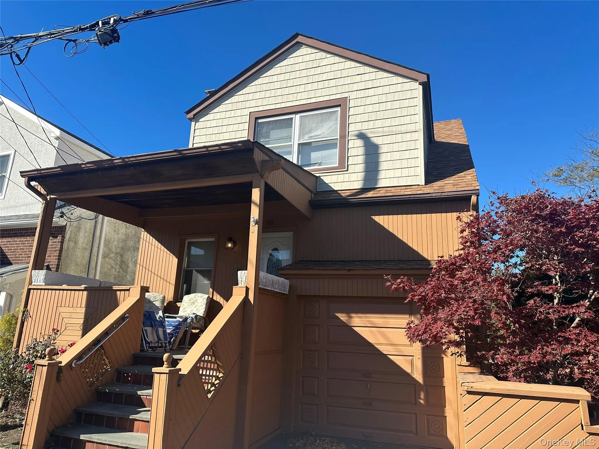 View of front of house with roof with shingles and a garage View of front of house with roof with shingles and a garage