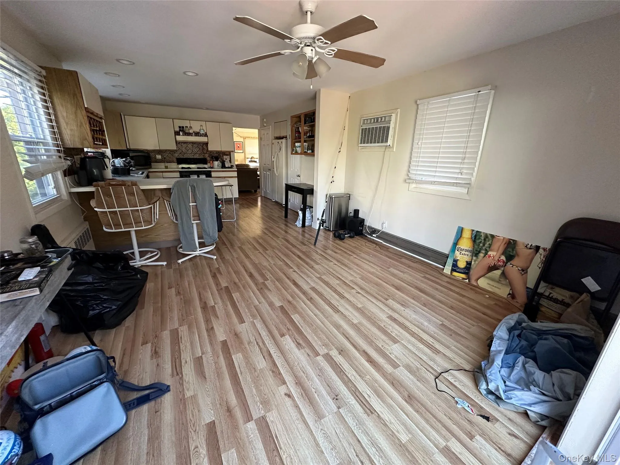 Living room featuring light wood-type flooring, a ceiling fan, and recessed lighting Living room featuring light wood-type flooring, a ceiling fan, and recessed lighting