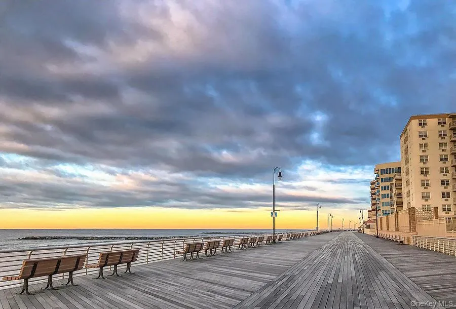 Deck at dusk with view of water and beach Deck at dusk with view of water and beach